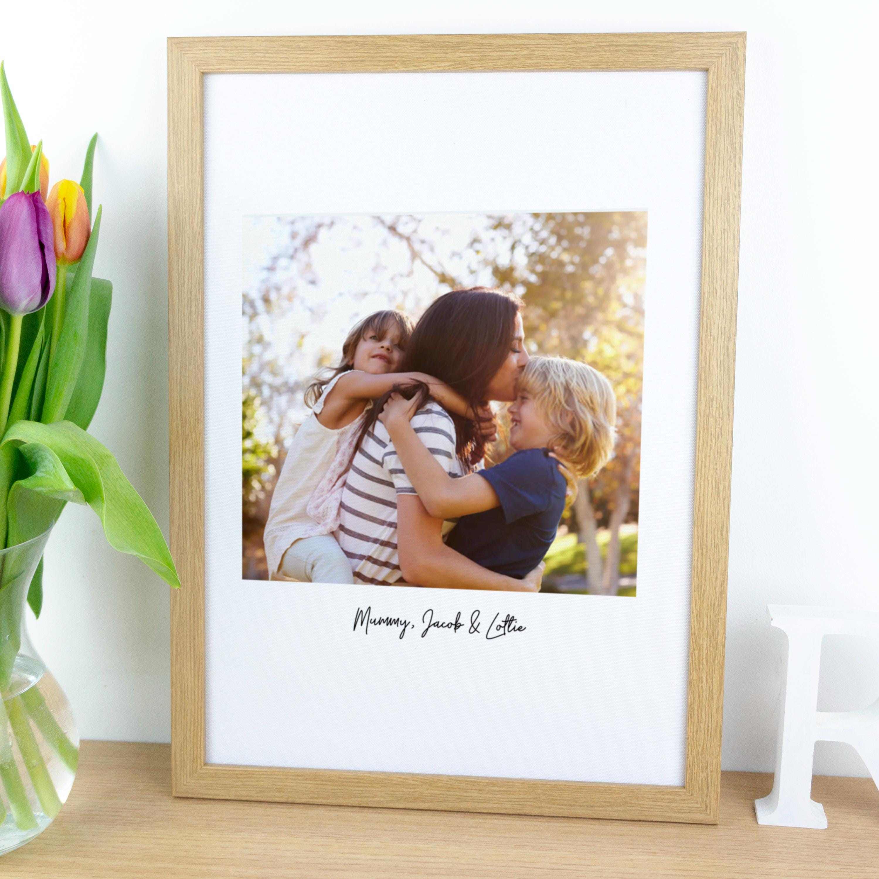 Framed photo print of new mother on cotton fabric.