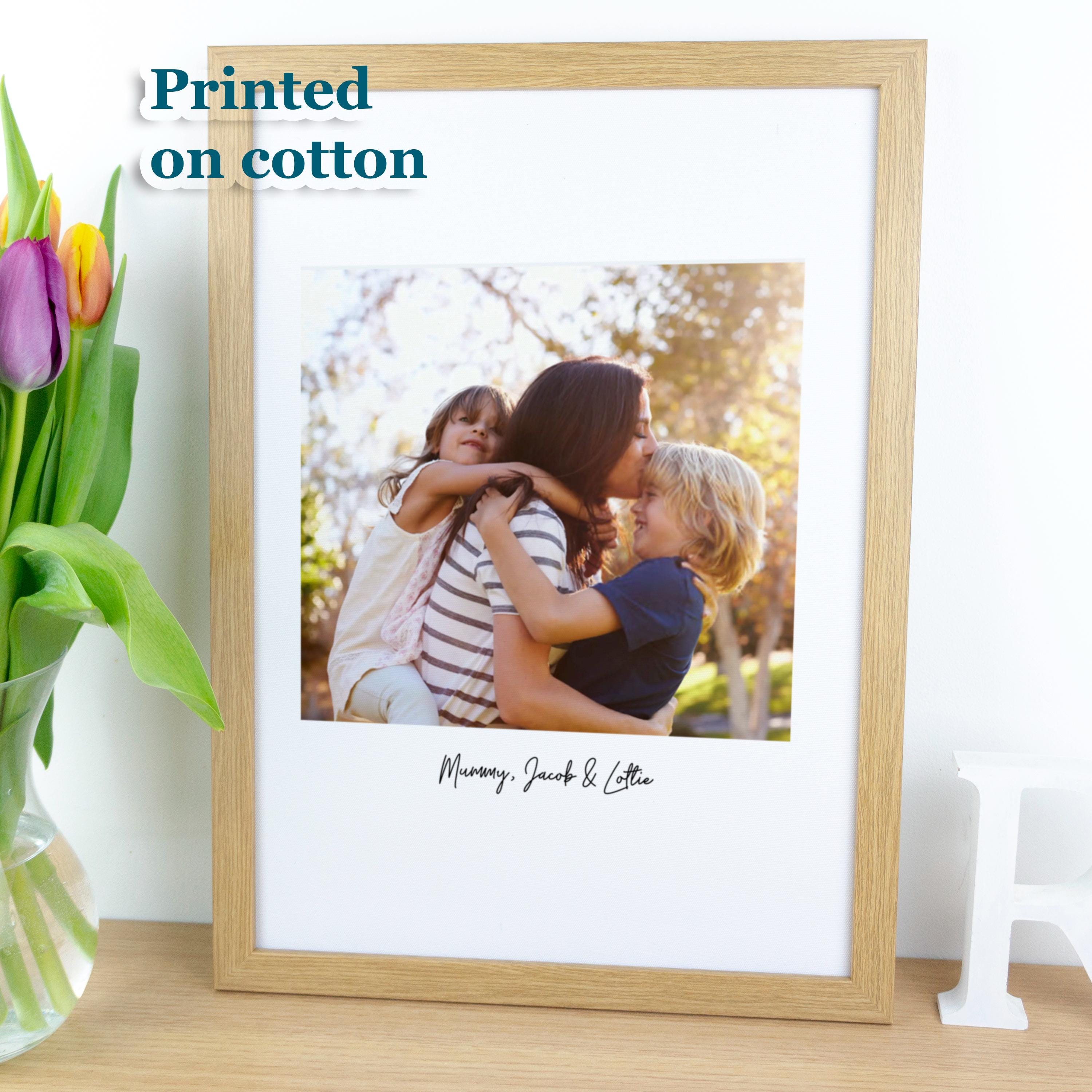 Framed photo print of new mother on cotton fabric.
